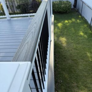 Custom deck stairs in Staten Island featuring gray composite decking and modern railing design.